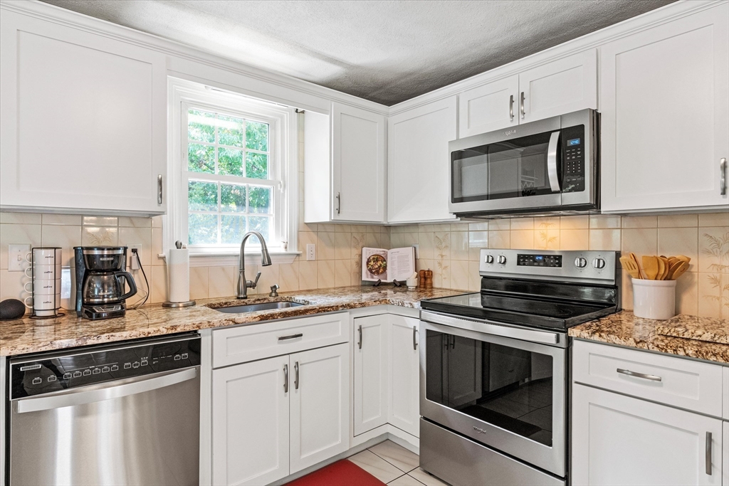 42 Crescent Saugus Ma Saugus, MA 01906 - Photo 5 of 38 a kitchen with cabinets stainless steel appliances a sink and a counter space