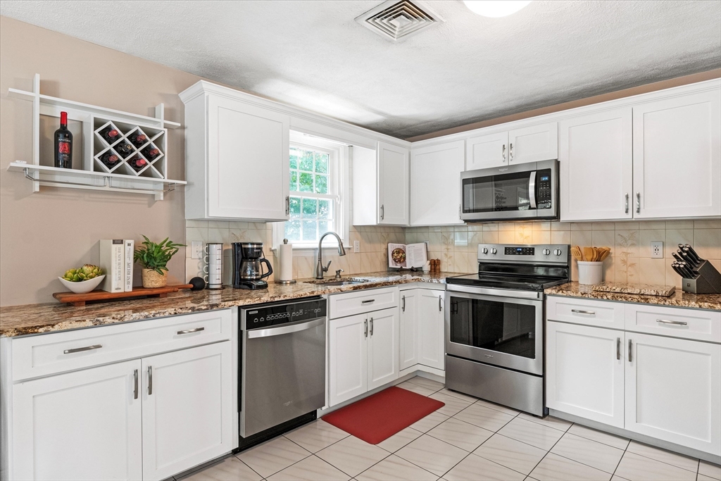 42 Crescent Saugus Ma Saugus, MA 01906 - Photo 6 of 38 a kitchen with white cabinets stainless steel appliances and a sink