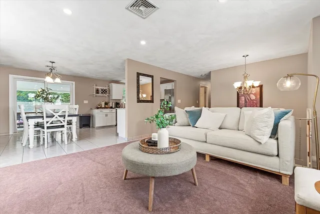 a living room with furniture and a dining table