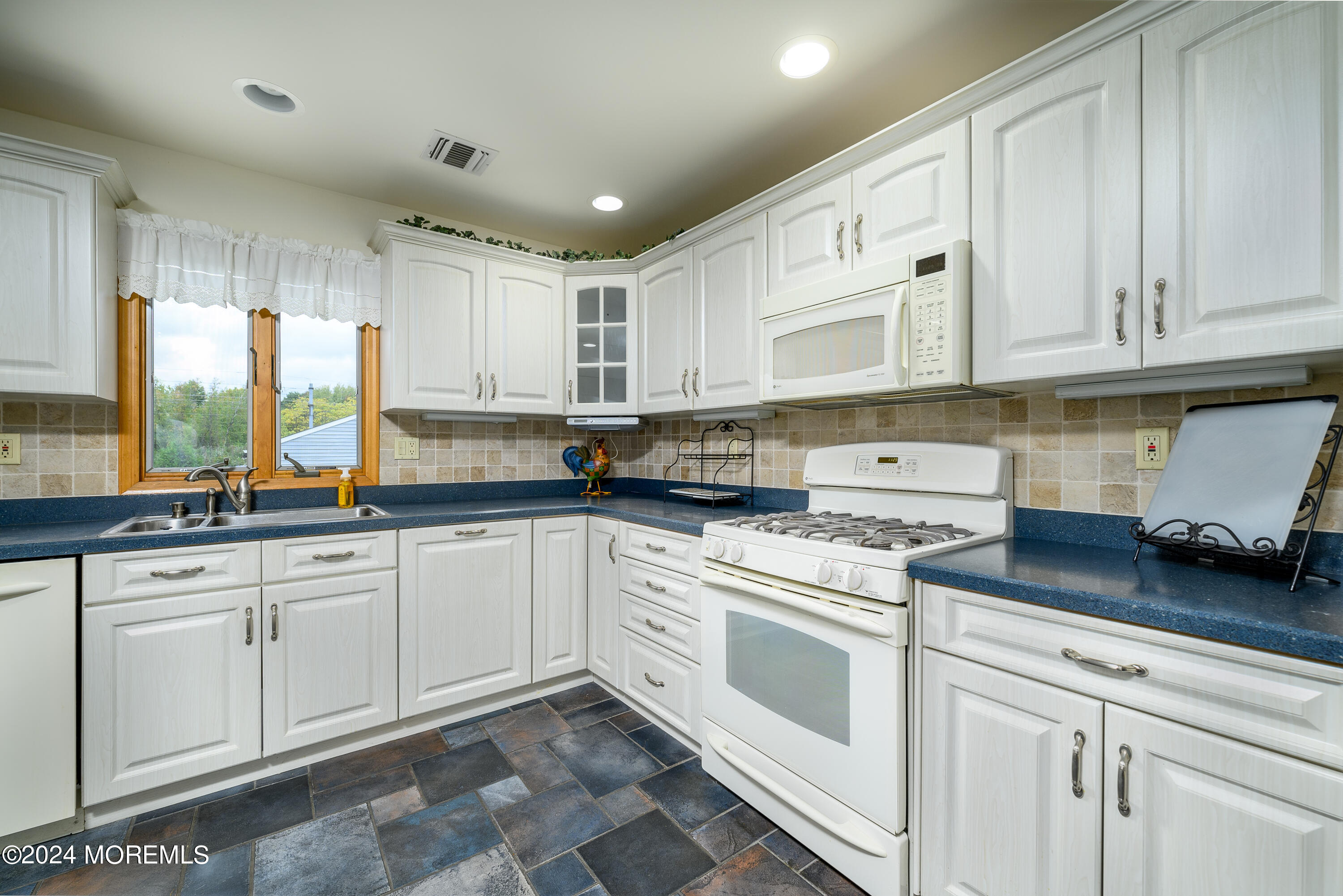 8 Parkview Drive Hazlet, NJ 07730 - Photo 8 of 40 a kitchen with cabinets appliances a sink and a window