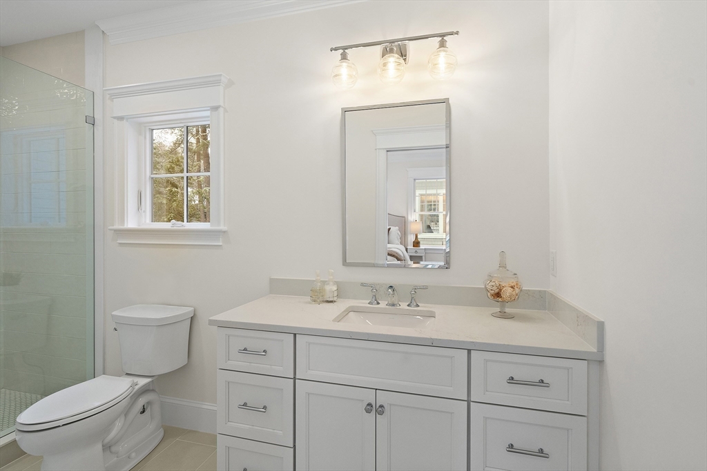 96 Independence Road Concord, MA 01742 - Photo 15 of 42 a bathroom with a toilet a sink a vanity a window and mirror