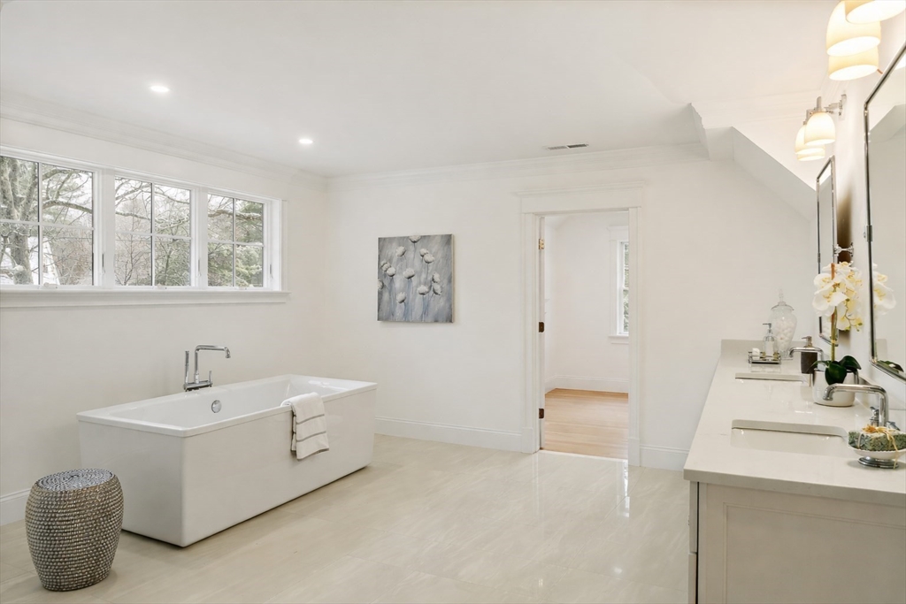 96 Independence Road Concord, MA 01742 - Photo 20 of 42 a bathroom with a double vanity sink a mirror and a bathtub