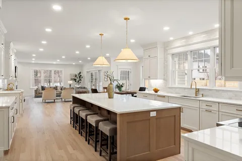 a kitchen with stainless steel appliances a sink stove and cabinets