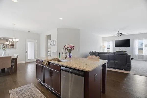 a kitchen with a stove a sink and a refrigerator
