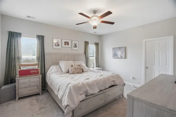a bedroom with a bed and a chandelier