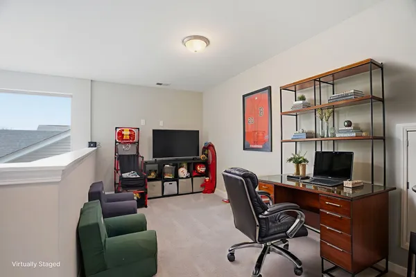 a work room with furniture and a flat screen tv