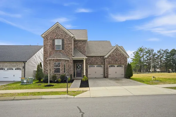 a view of a house with a yard and plants