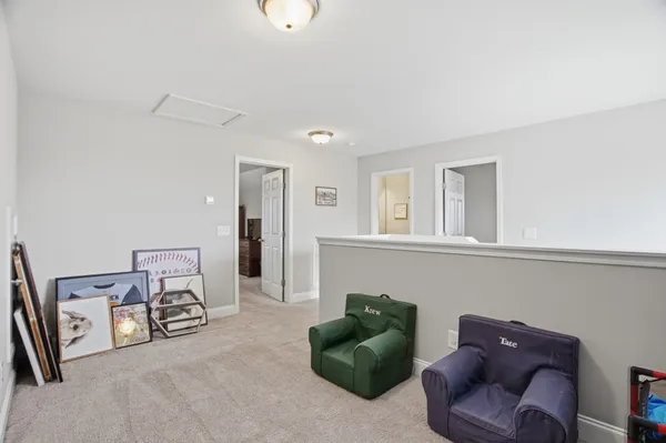 a living room with furniture and a chair