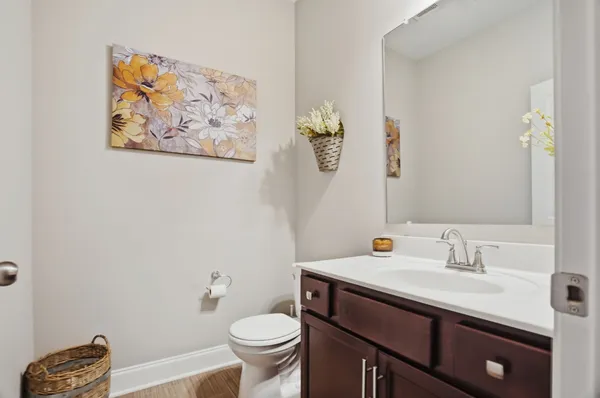 a bathroom with a sink mirror vanity and toilet