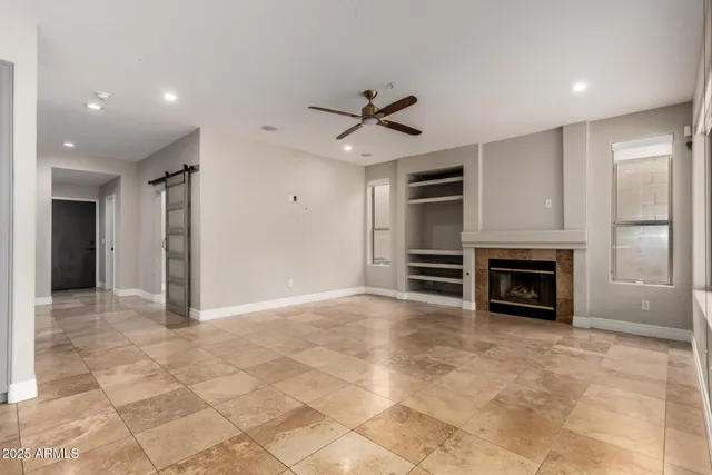 a view of livingroom with kitchen and fireplace