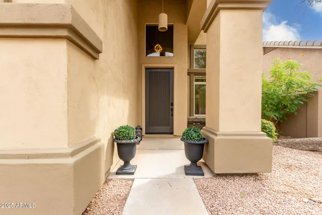 a view of a balcony with chair and potted plants