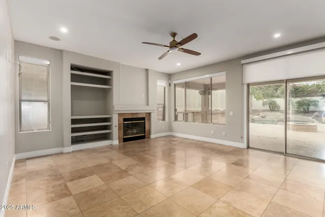 a view of an empty room with a fireplace and cabinet
