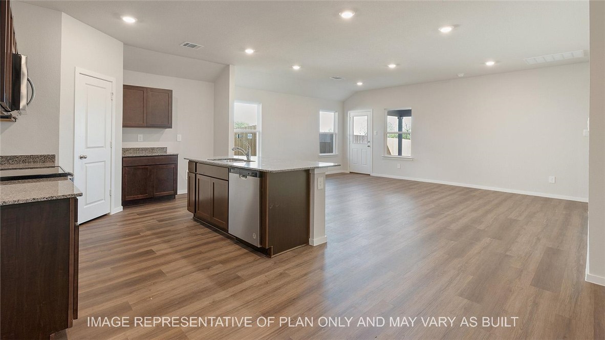 5416 Bear Run Bryan, TX 77807 - Photo 18 of 19 a large kitchen with stainless steel appliances a large counter top and a stove