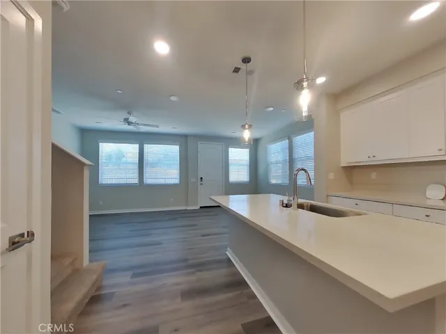 a large kitchen with kitchen island a sink stainless steel appliances and a counter space