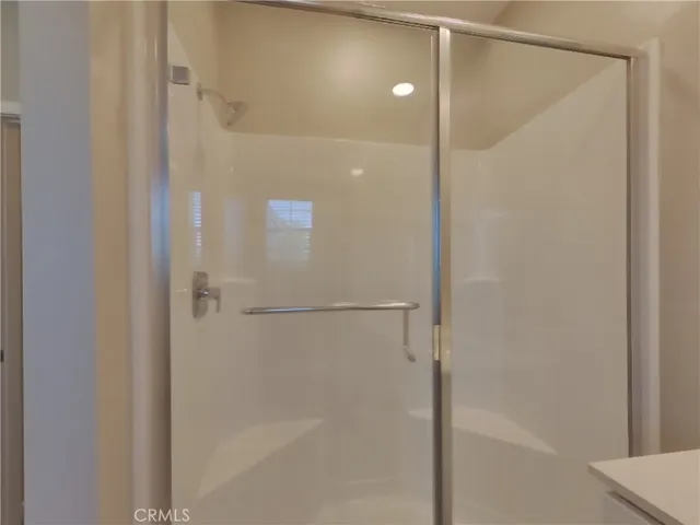 a bathroom with a glass shower door