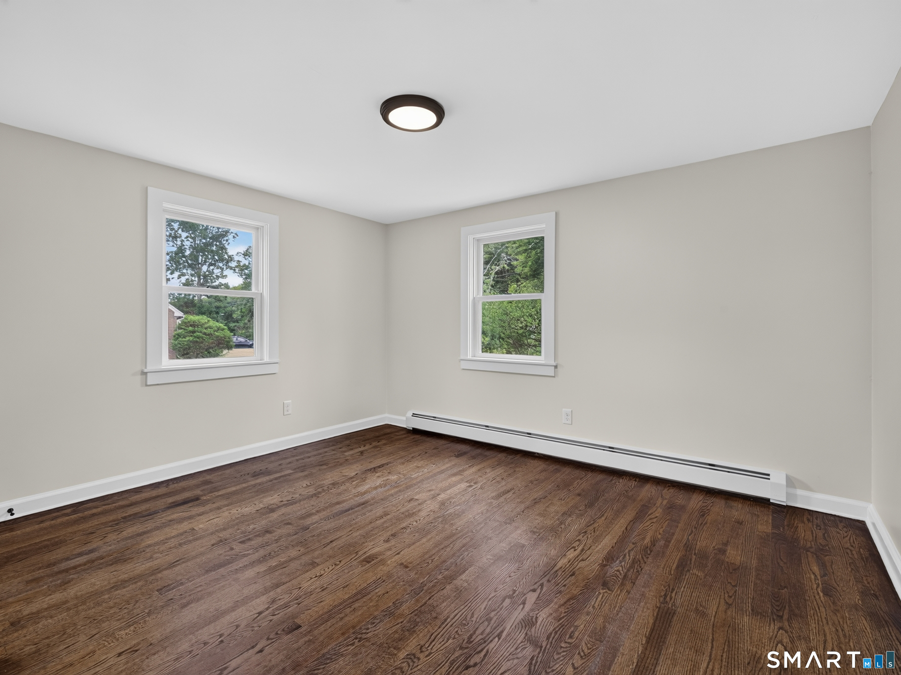 1039 N Road Groton, CT 06340 - Photo 11 of 26 an empty room with wooden floor and windows