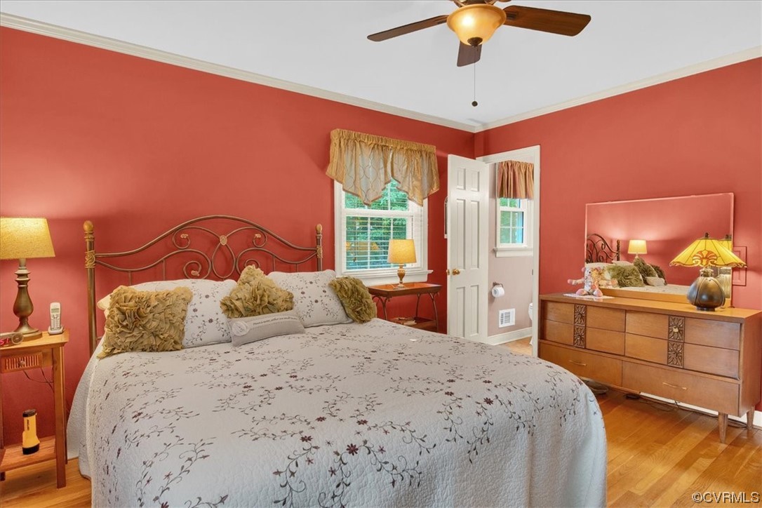 900 Ryder Road Richmond, VA 23235 - Photo 17 of 47 a bedroom with a large bed and a chandelier
