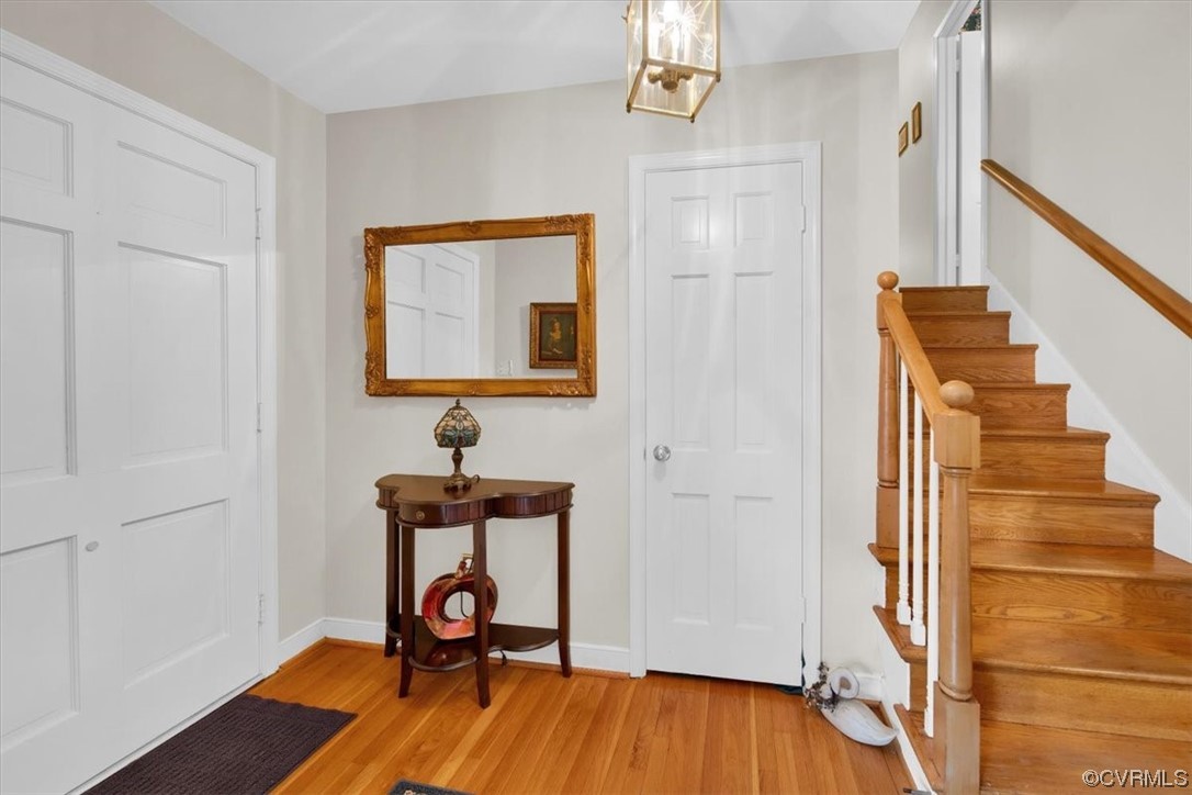 900 Ryder Road Richmond, VA 23235 - Photo 5 of 47 a view of a hallway with wooden floor and staircase