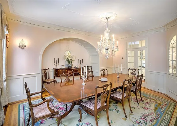 a living room with furniture chandelier and a fireplace