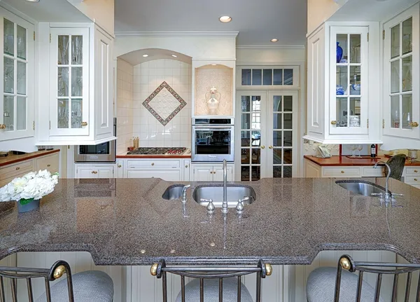 a view of a dining room with furniture water view and large windows