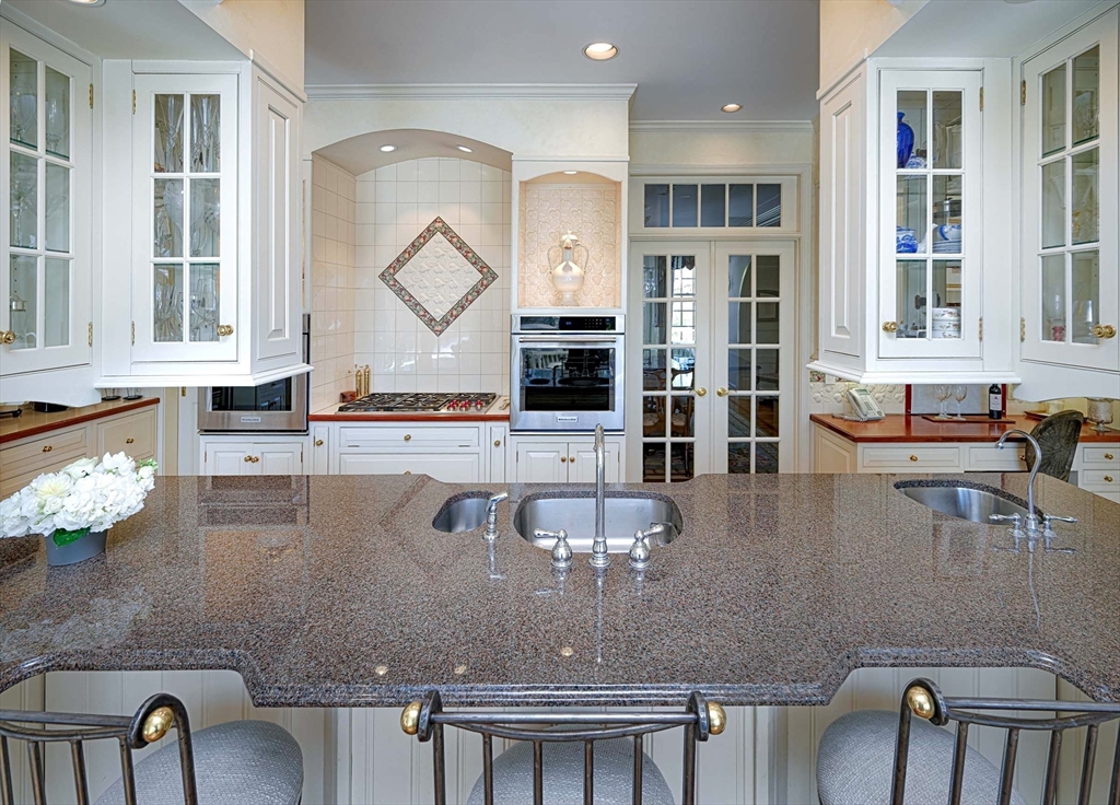 32 Sears Road Southborough, MA 01772 - Photo 13 of 41 a view of kitchen and dining area with chandelier