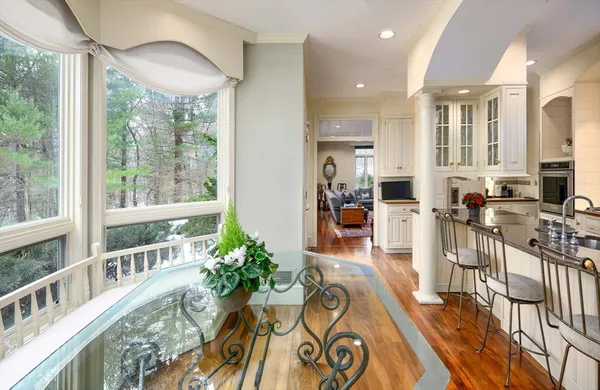 a large kitchen with stainless steel appliances a stove a sink dishwasher and cabinets with wooden floor