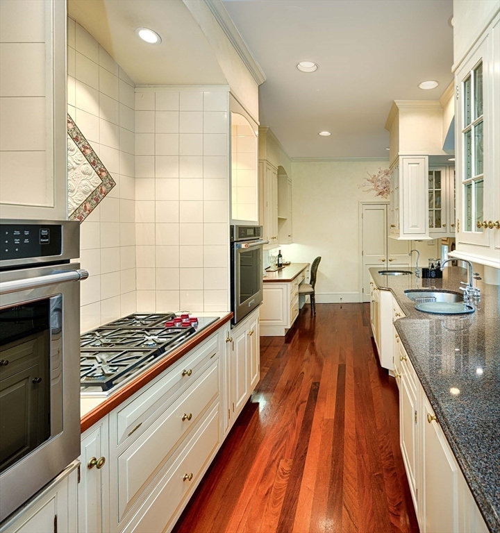 32 Sears Road Southborough, MA 01772 - Photo 15 of 41 a large kitchen with stainless steel appliances a stove a sink dishwasher and cabinets with wooden floor