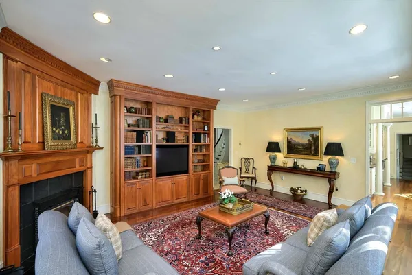 a living room with furniture and a chandelier
