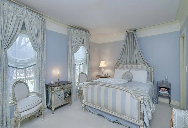 a bedroom with a bed couch and a window