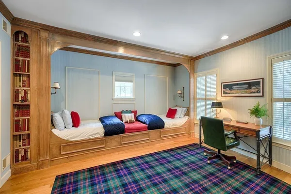 a bed room with a bed and a book shelf