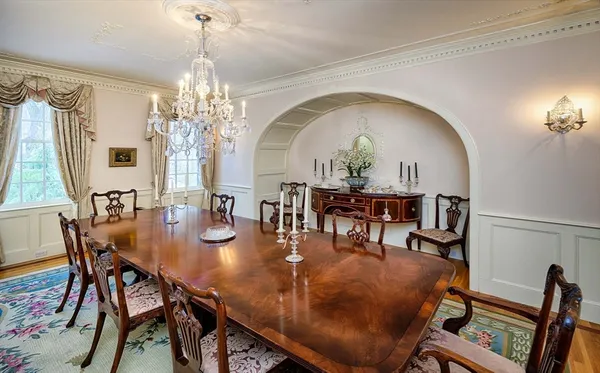 a view of a dining room with furniture and chandelier