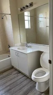 a bathroom with a toilet a sink and bathtub