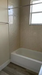 a bathroom with a bathtub and a shower