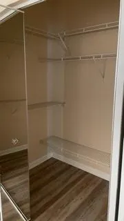 a empty closet with wooden floor