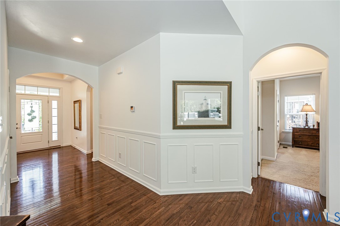 7435 Wicks Road Williamsburg, VA 23188 - Photo 51 of 82 Foyer featuring wood-finish flooring, white wainsc
