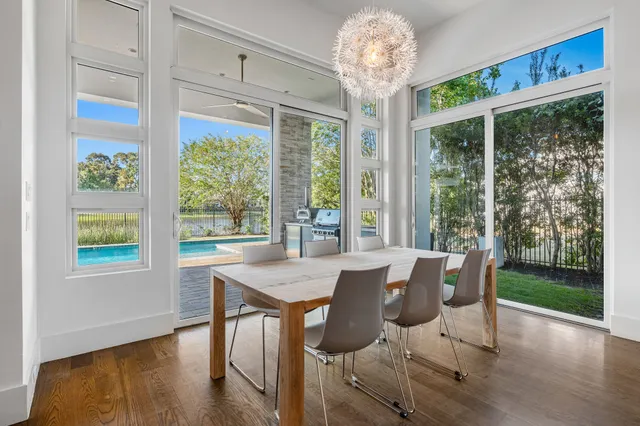 an empty room with wooden floor closet and windows