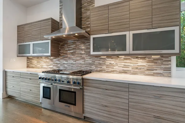 a bedroom with a large bed a flat screen tv and a large window