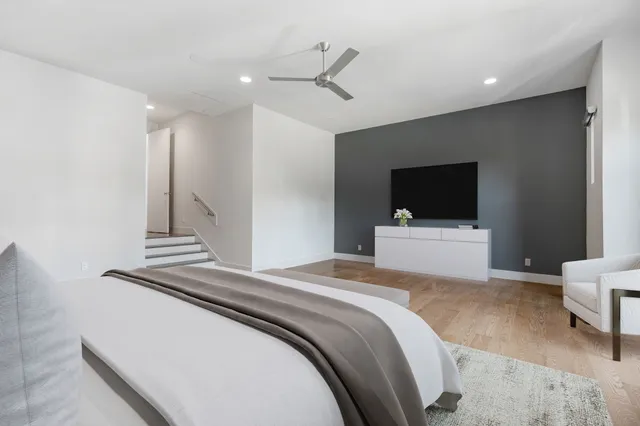 a spacious bedroom with a bed and a couch