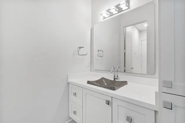 a view of a kitchen with a sink and wooden floor