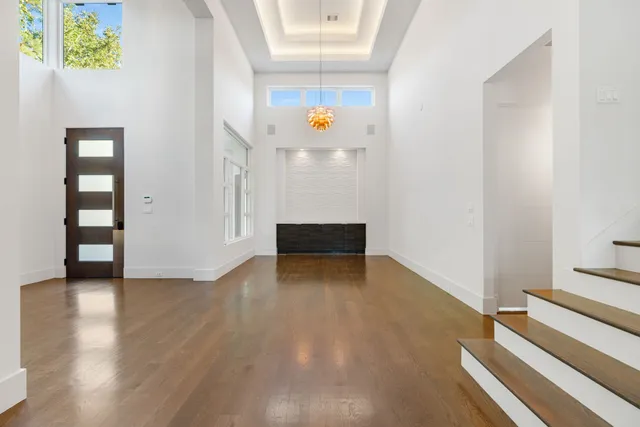 a view of dining room with floor to ceiling window and wooden floor