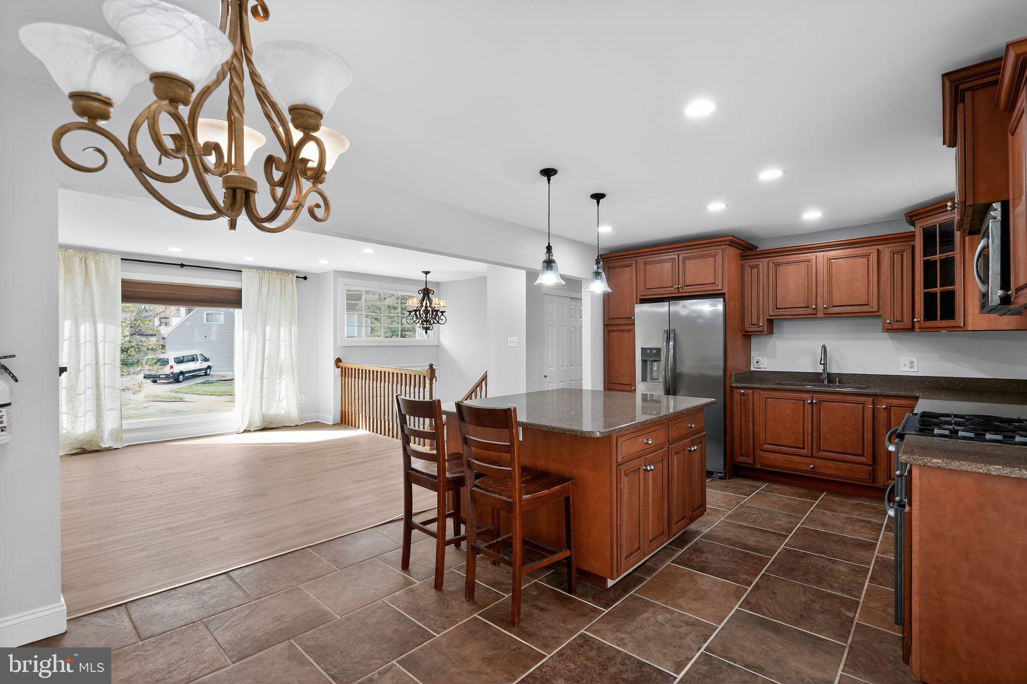 73 Greenvale Road Cherry Hill, NJ 08034 - Photo 4 of 23 a kitchen with stainless steel appliances granite countertop a sink and a refrigerator