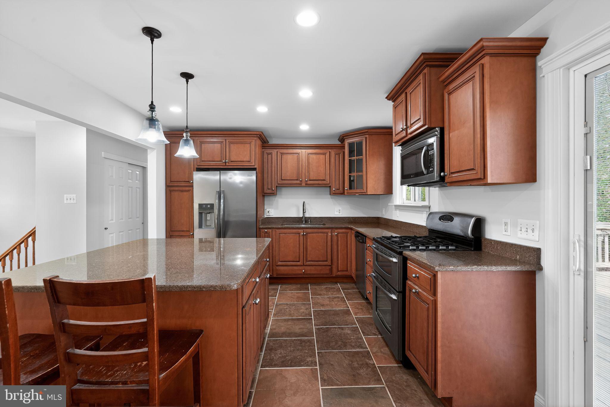 73 Greenvale Road Cherry Hill, NJ 08034 - Photo 5 of 23 a large kitchen with stainless steel appliances granite countertop a stove a sink and a refrigerator