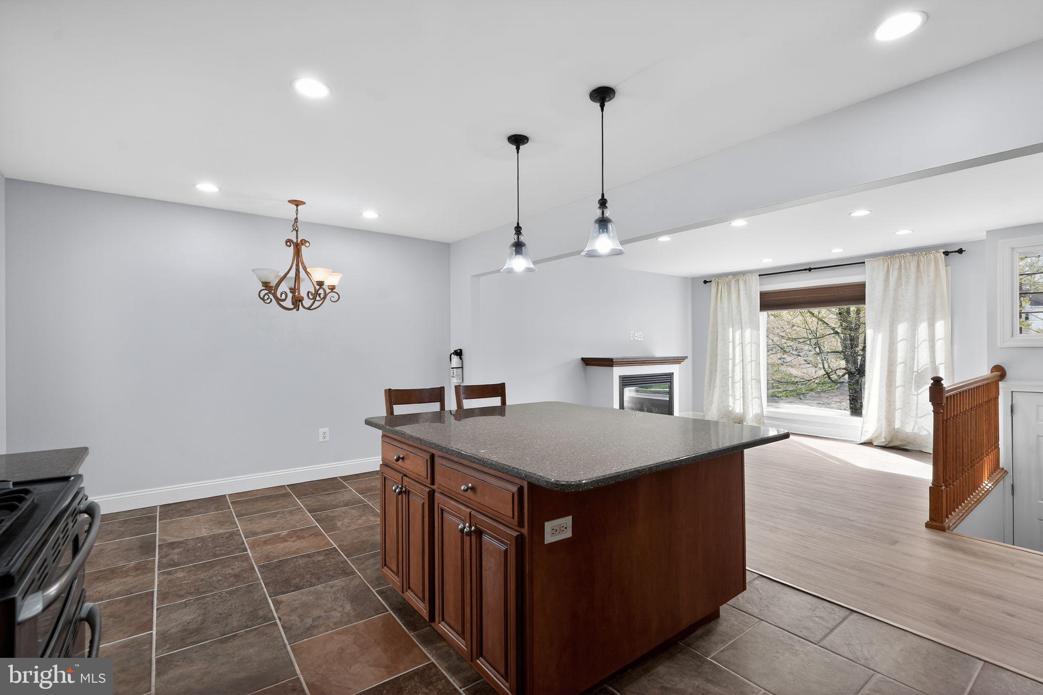 73 Greenvale Road Cherry Hill, NJ 08034 - Photo 6 of 23 a dining hall with stainless steel appliances granite countertop a sink dishwasher a stove a dining table and chairs with wooden floor