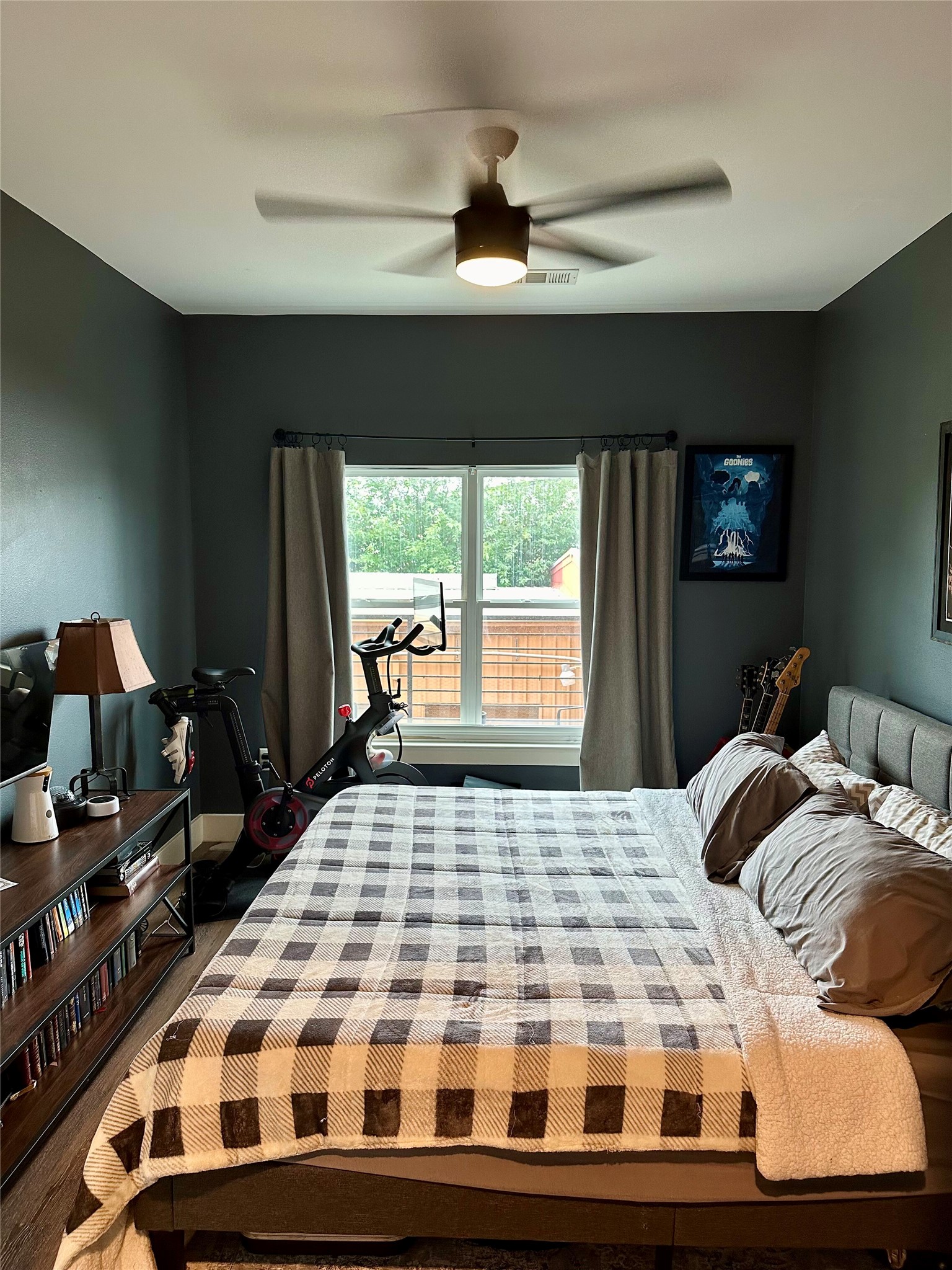 6444 Burnet Road, Unit 203 Austin, TX 78757 - Photo 14 of 30 This bedroom features dark walls, a ceiling fan, and a window with blinds and curtains