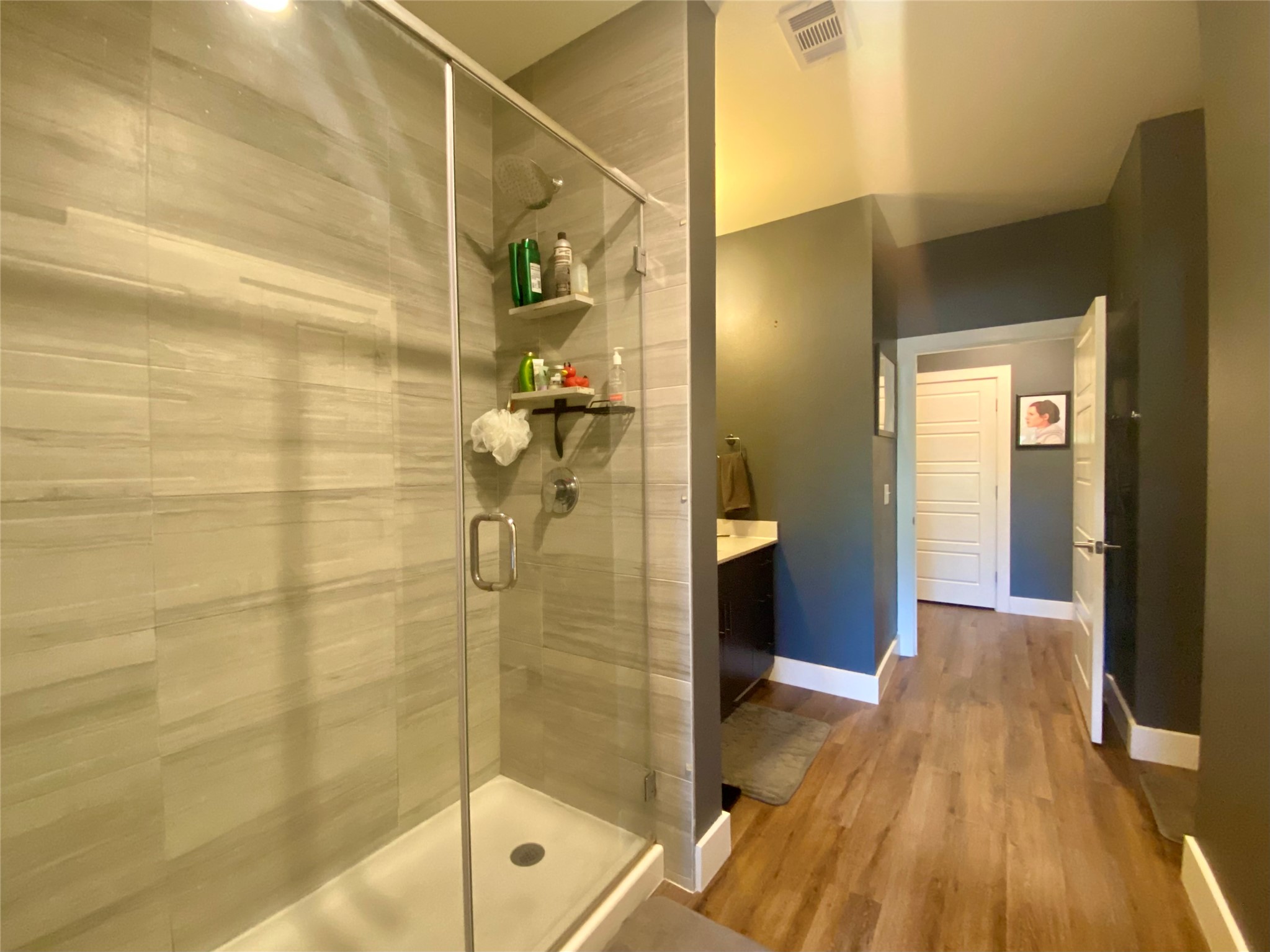 6444 Burnet Road, Unit 203 Austin, TX 78757 - Photo 18 of 30 This bathroom features a spacious glass-enclosed shower with light-toned tiled walls and a white shower pan