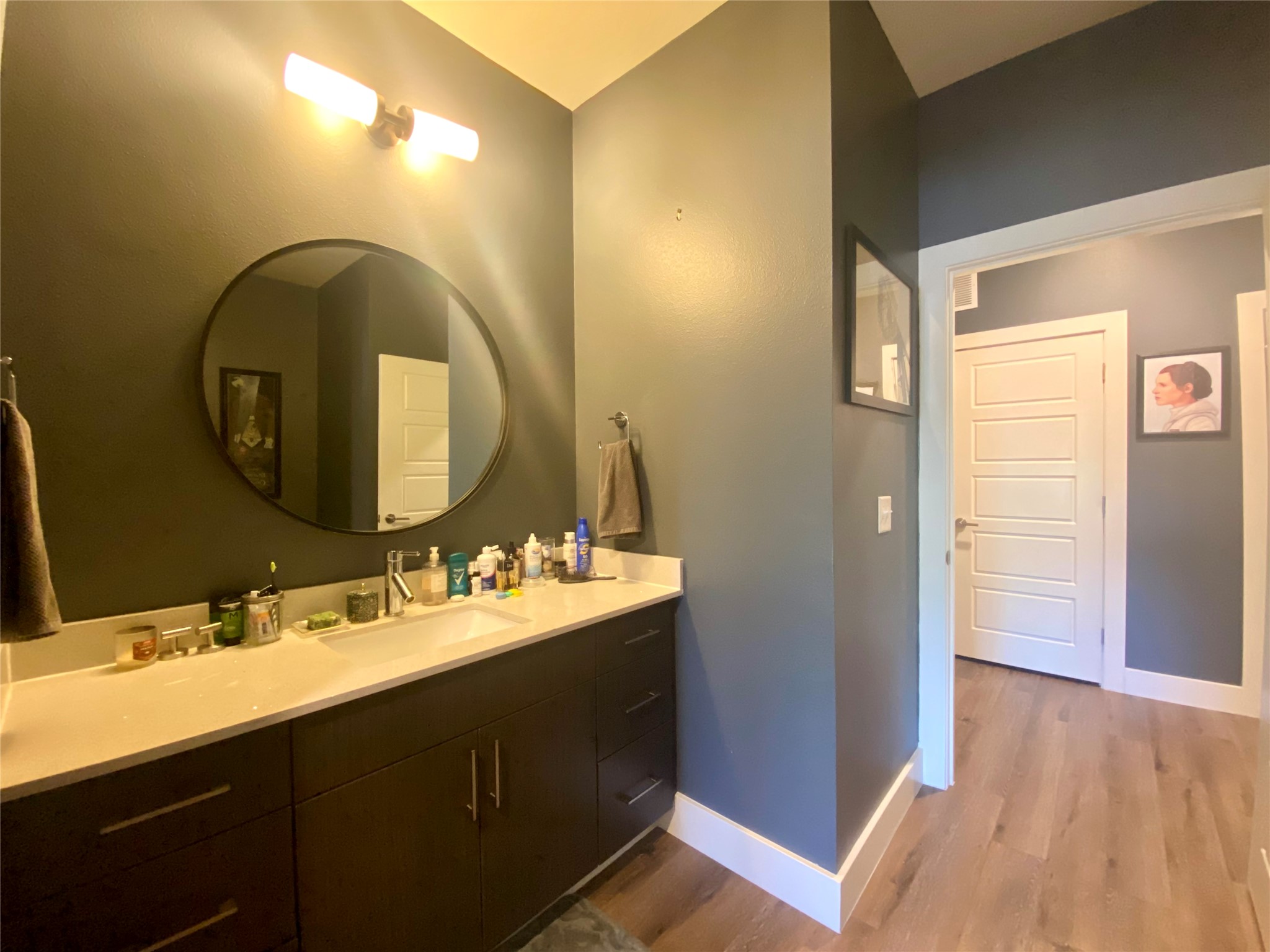 6444 Burnet Road, Unit 203 Austin, TX 78757 - Photo 19 of 30 Bathroom featuring a vanity with a white countertop, a circular mirror, and overhead lighting