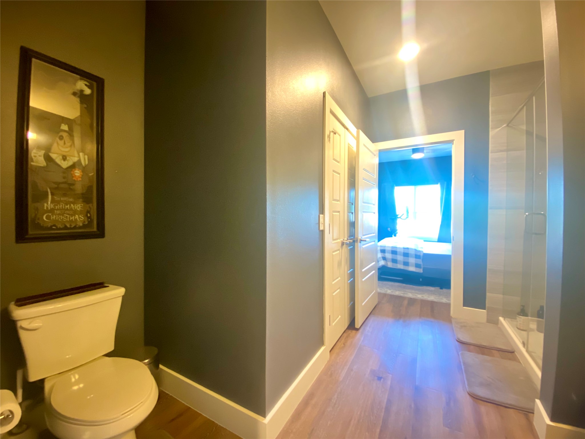6444 Burnet Road, Unit 203 Austin, TX 78757 - Photo 20 of 30 This bathroom features hardwood flooring, a toilet, and a glass-enclosed shower