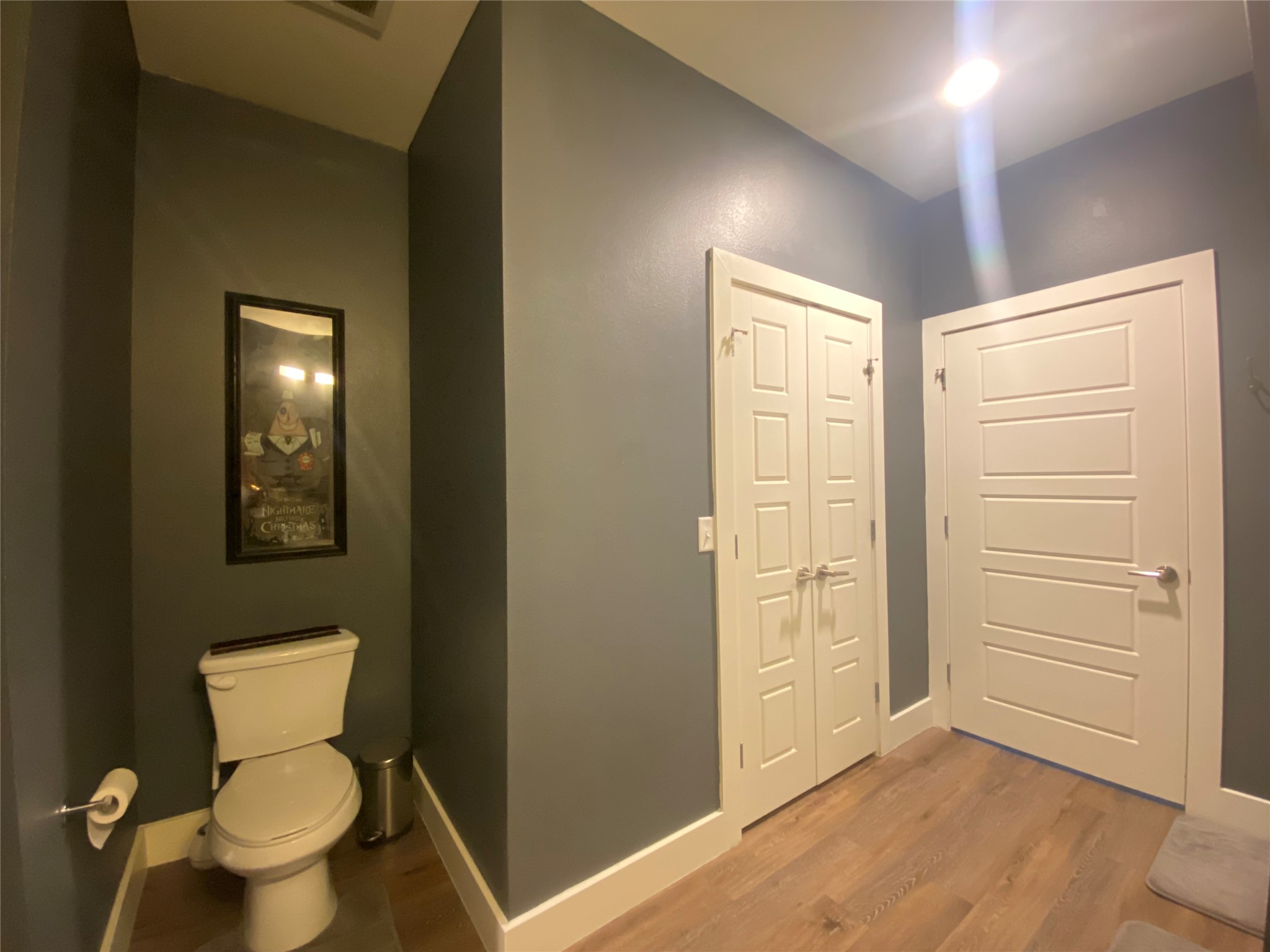 6444 Burnet Road, Unit 203 Austin, TX 78757 - Photo 21 of 30 This room features hardwood flooring, white trim, and a combination of white paneled and bi-fold doors