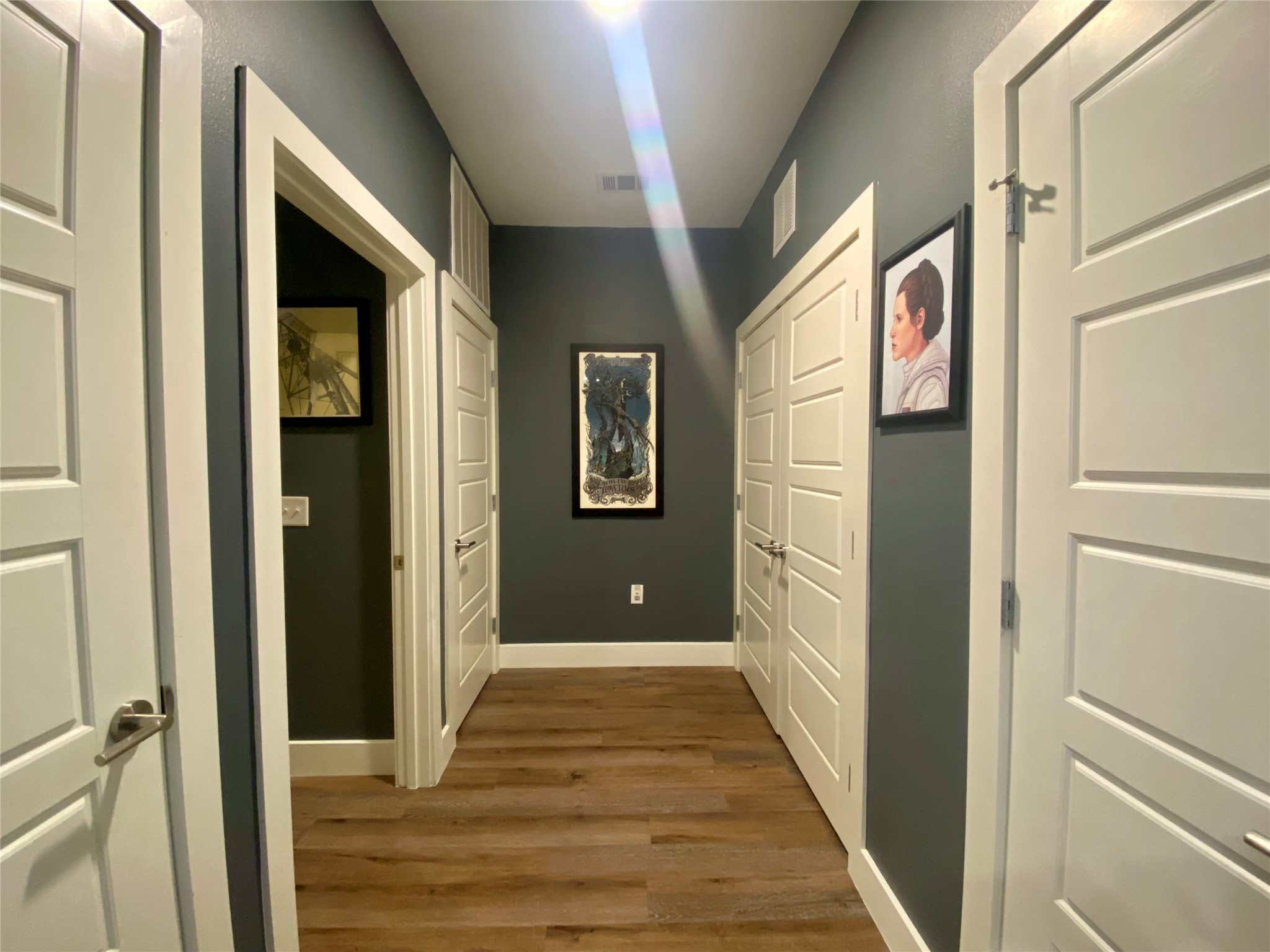 6444 Burnet Road, Unit 203 Austin, TX 78757 - Photo 22 of 30 Hallway featuring wood-look flooring and dark-painted walls
