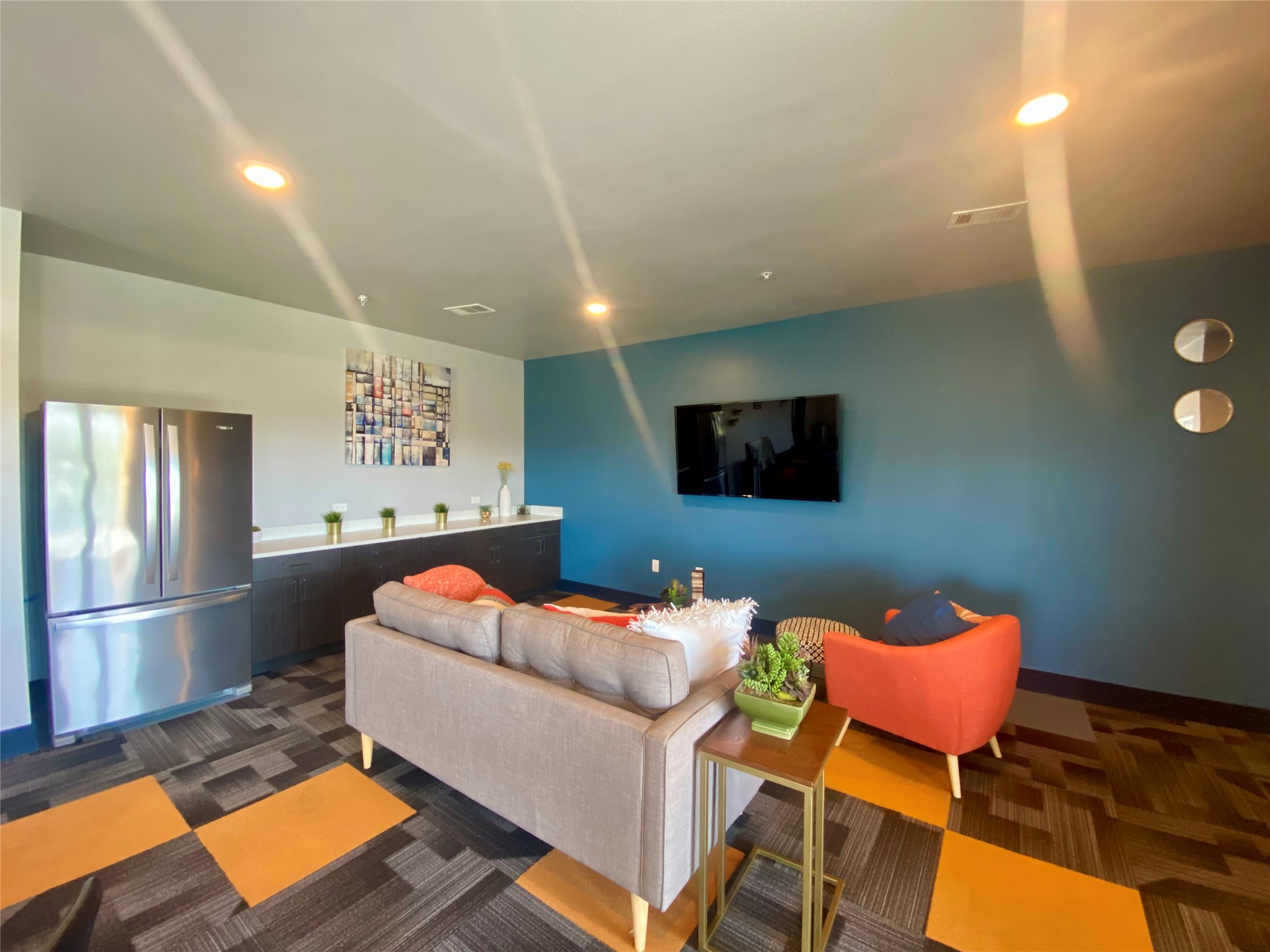 6444 Burnet Road, Unit 203 Austin, TX 78757 - Photo 26 of 30 This versatile living area features a stainless steel refrigerator, built-in cabinetry with a light-colored countertop, and recessed lighting